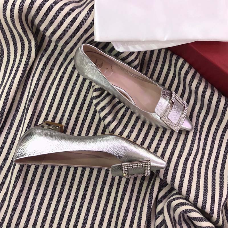 Top-down look at silver leather and Gommettine studs on Roger Vivier ballerinas