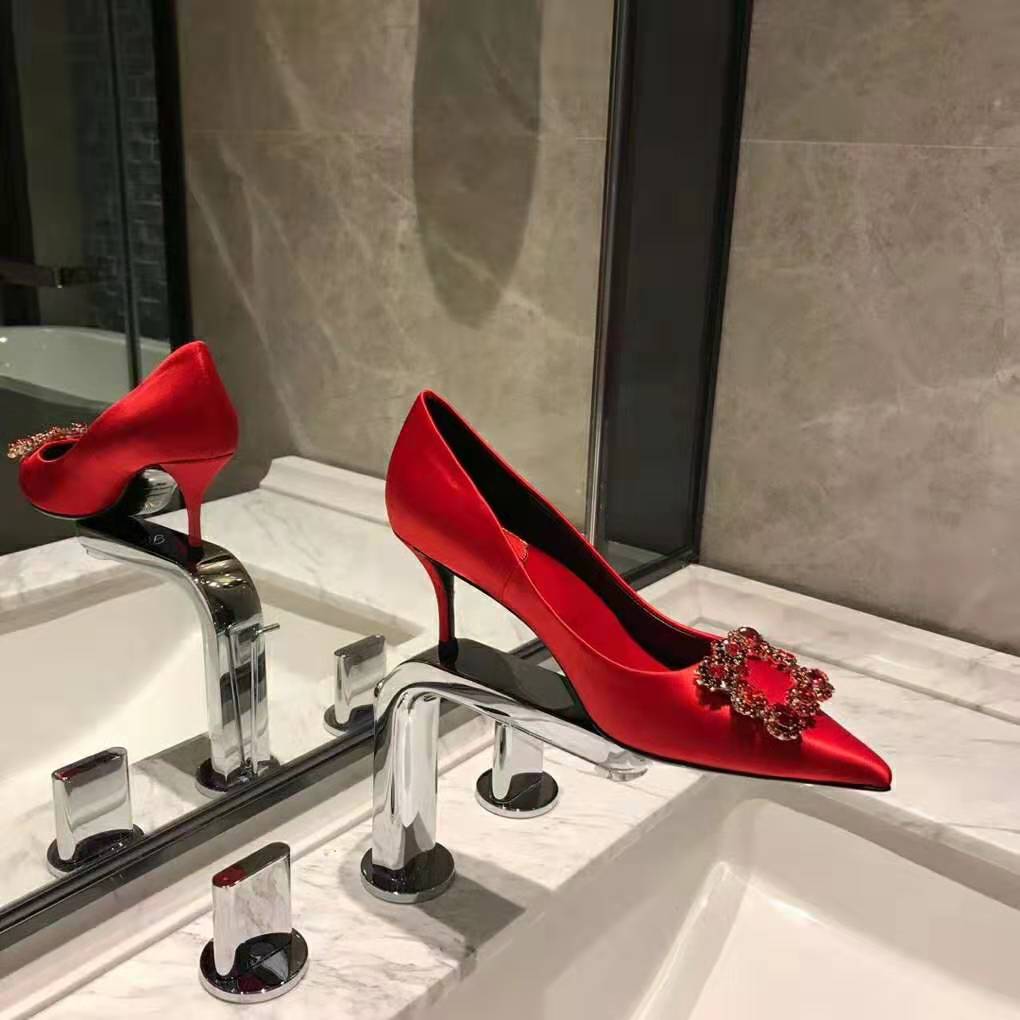 Close-up of red silk and sparkling strass flower detail on Roger Vivier pumps