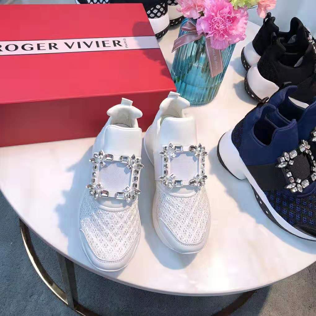 Close-up of sparkling strass buckle on Roger Vivier white sneakers