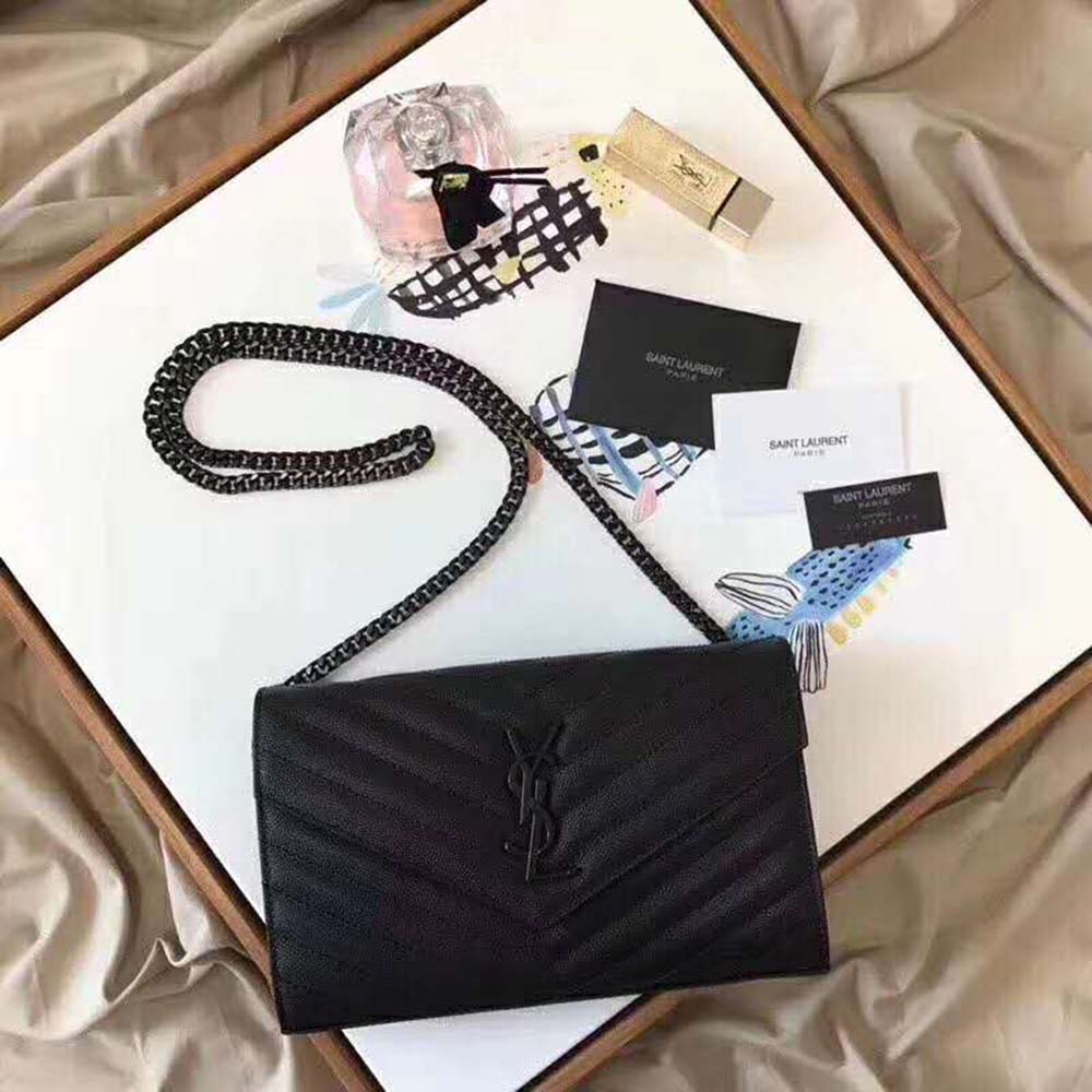 Close-up of gold YSL monogram hardware on Saint Laurent Chain Wallet