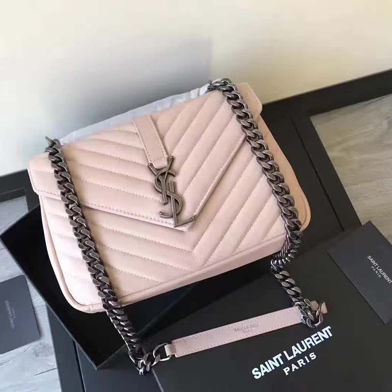 Close-up of YSL gold-tone clasp on pink leather bag