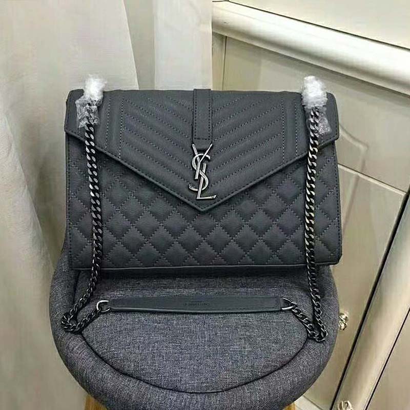 Close-up of gold-tone YSL logo hardware on Saint Laurent YSL shoulder bag