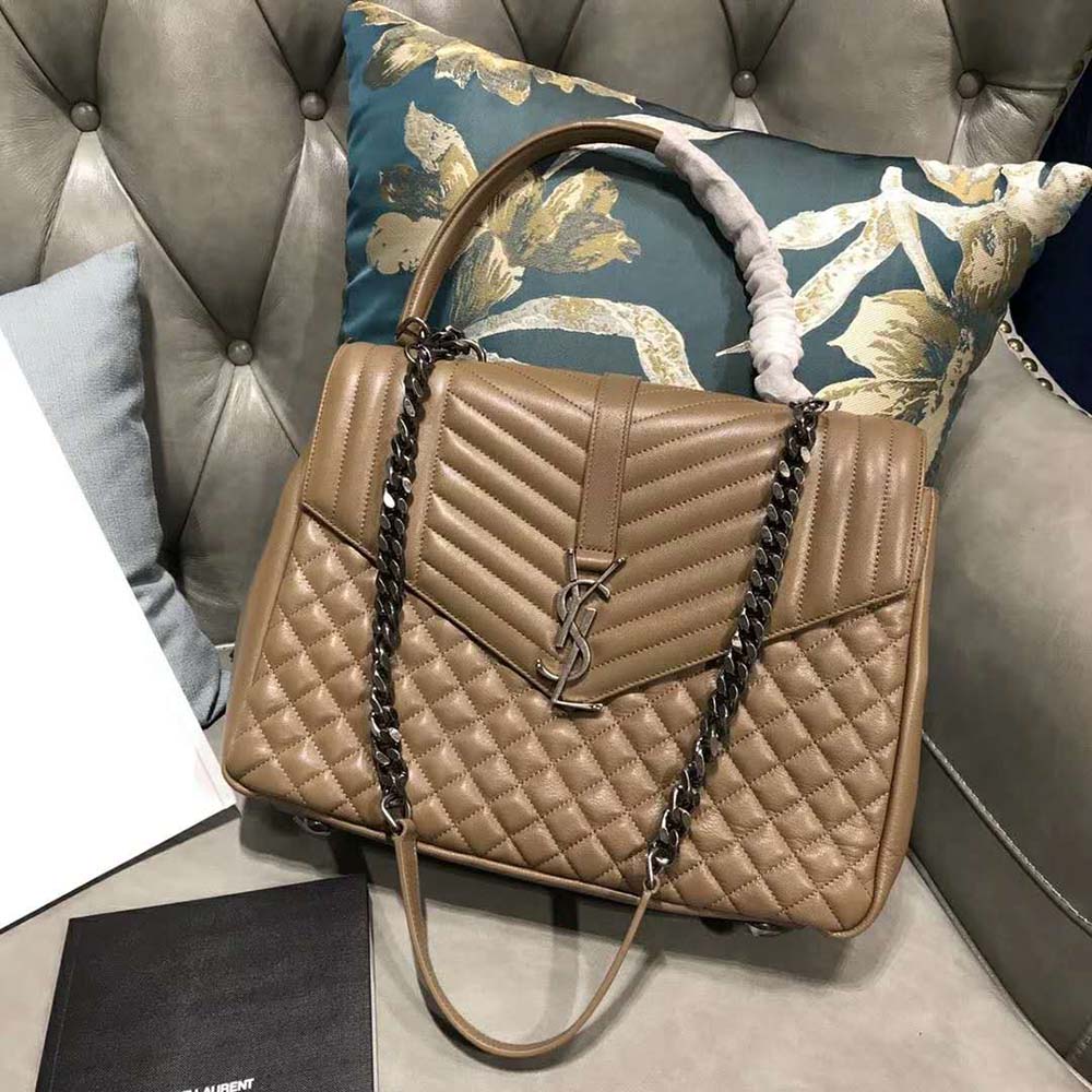 Close-up of sandy mixed grain leather and gold YSL logo