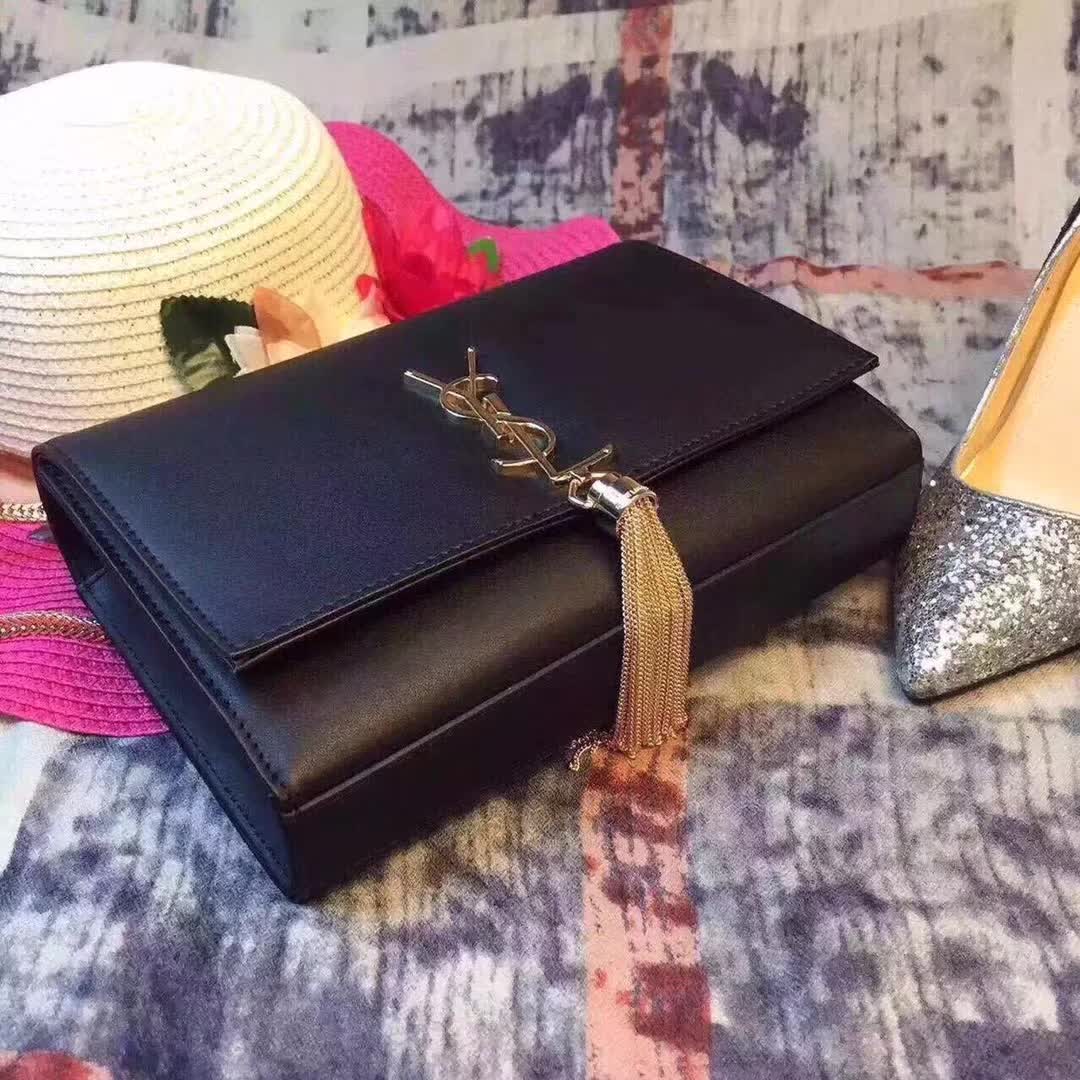 Side angle showing chain strap and smooth black calfskin leather texture