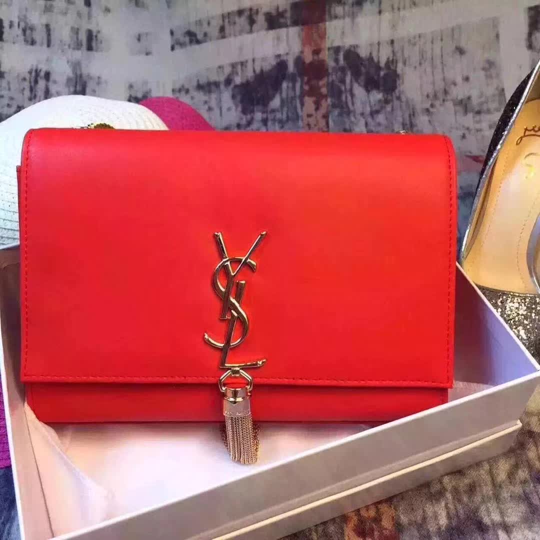 Close-up of gold YSL logo and tassel detail on Saint Laurent Kate bag