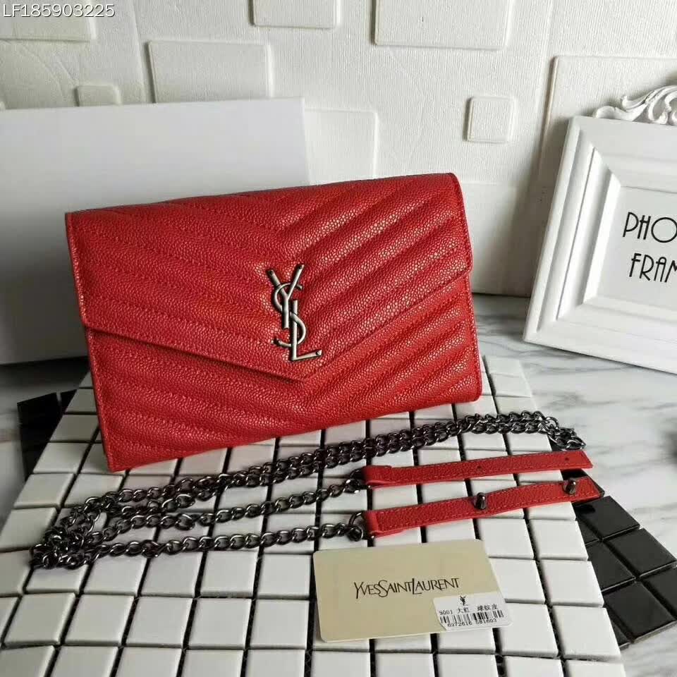 Close-up of silver YSL monogram hardware on red envelope chain wallet
