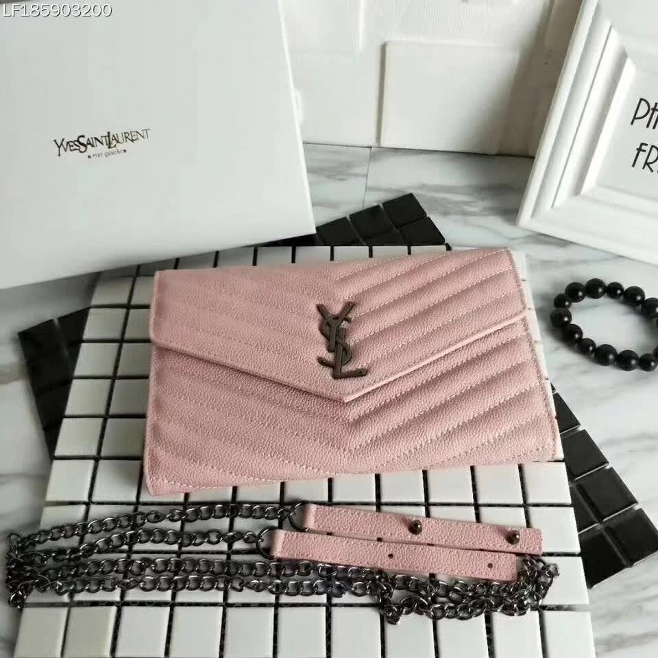 Close-up of silver YSL monogram and chain detail on pink wallet