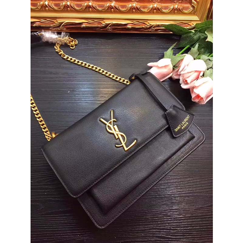 Close-up of gold YSL logo hardware on Saint Laurent Medium Sunset Bag