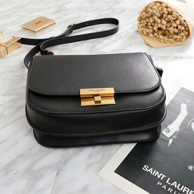 Close-up of gold YSL logo hardware on Betty Satchel black leather