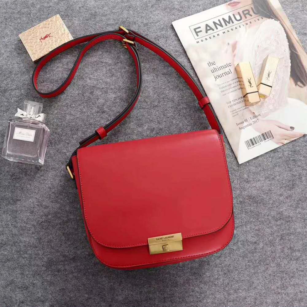 Close-up of gold YSL logo hardware on red leather Betty Satchel