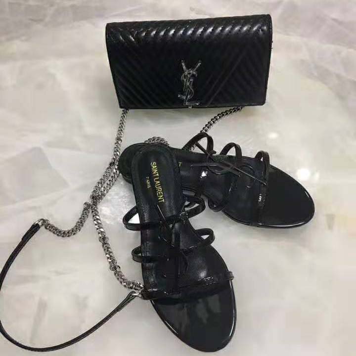 Side profile showing patent leather and open toe on Saint Laurent sandals
