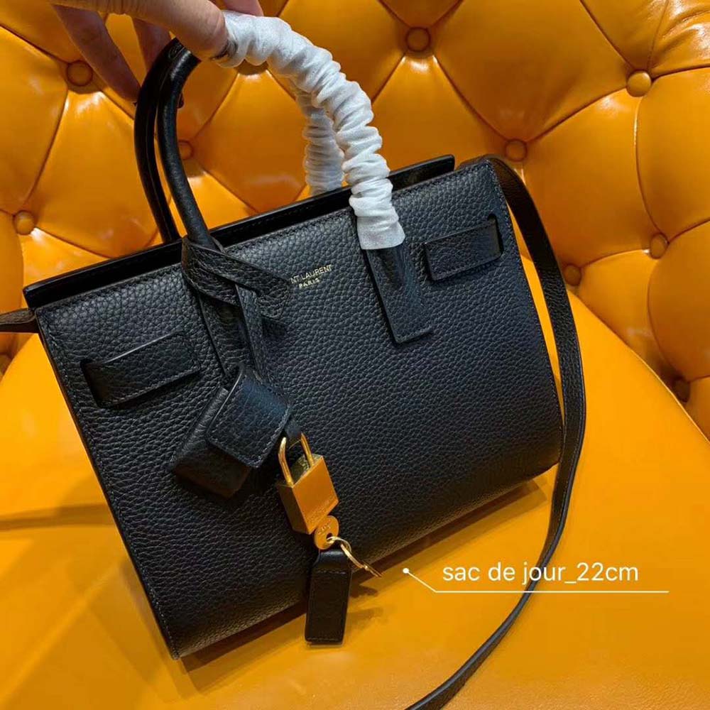 Close-up of gold YSL logo hardware on Sac De Jour Nano black bag