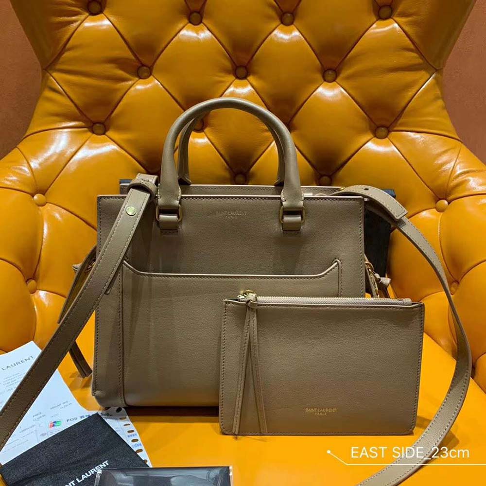 Close-up of gold-tone YSL logo on East Side Small Tote Bag Sandy
