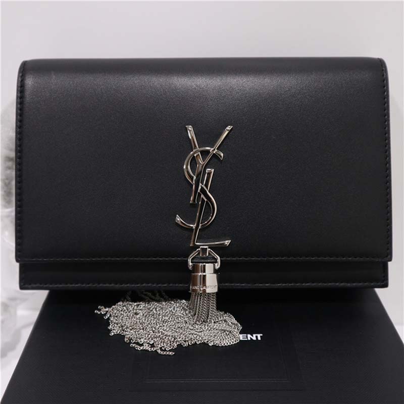 Close-up of gold-tone YSL tassel and chain on Saint Laurent YSL bag