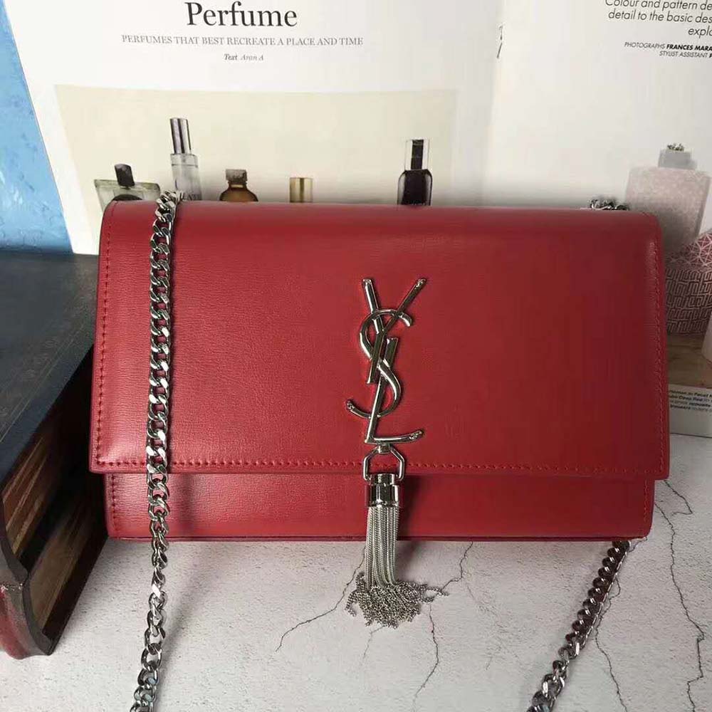Close-up of red smooth leather and gold YSL tassel detail