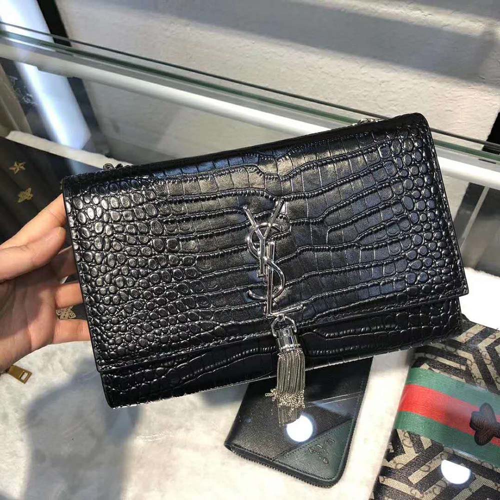 Close-up of gold YSL logo and tassel on Saint Laurent YSL Women Kate Small Tassel Crocodile Embossed Leather-Black