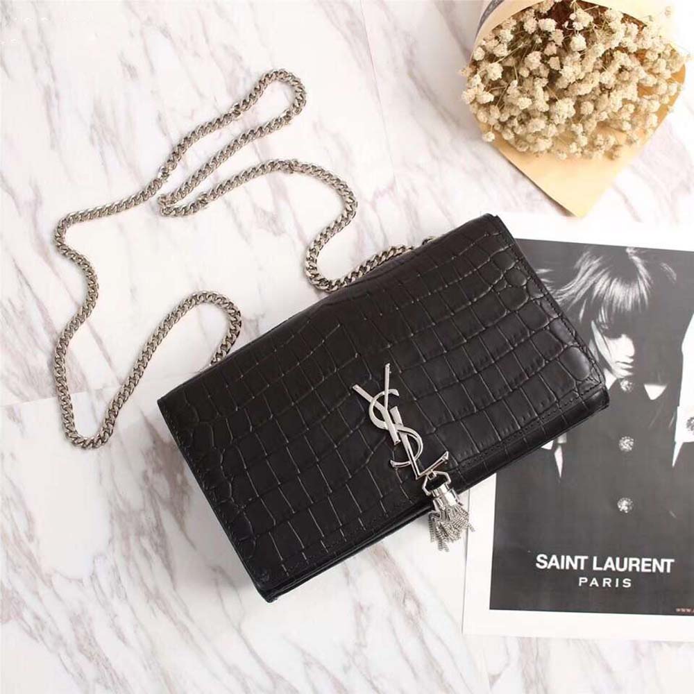 Close-up of embossed crocodile shiny calfskin and gold YSL hardware detail