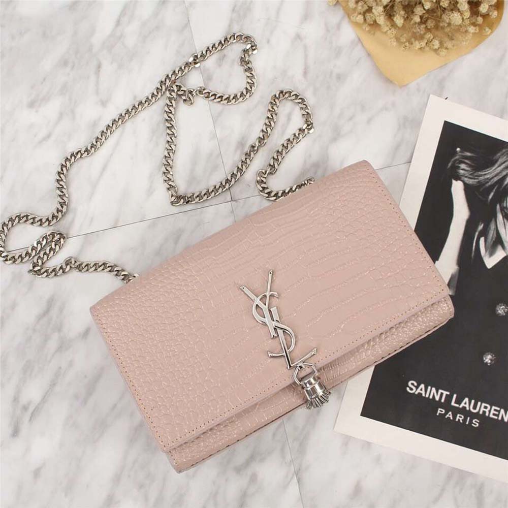 Side angle showing tassel charm and gold chain strap on Saint Laurent YSL bag