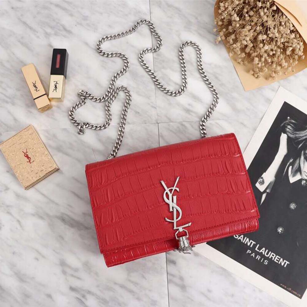 Close-up of gold YSL hardware and tassel on Kate Small bag red