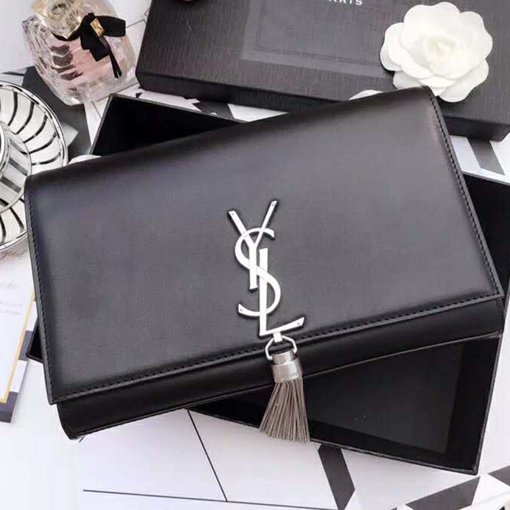 Close-up on gold-tone YSL tassel hardware detail on Saint Laurent Kate bag
