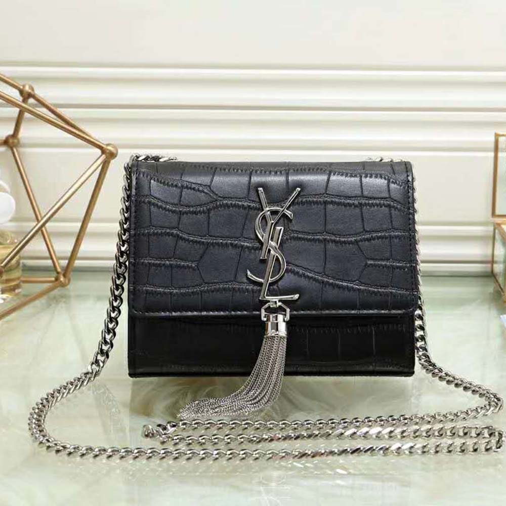 Close-up detail of gold YSL tassel on wallet chain