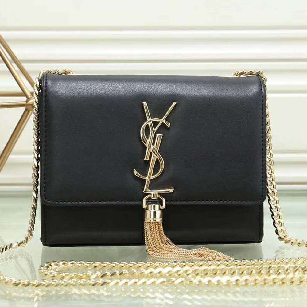 Close-up of gold YSL logo and tassel detail on Saint Laurent YSL wallet