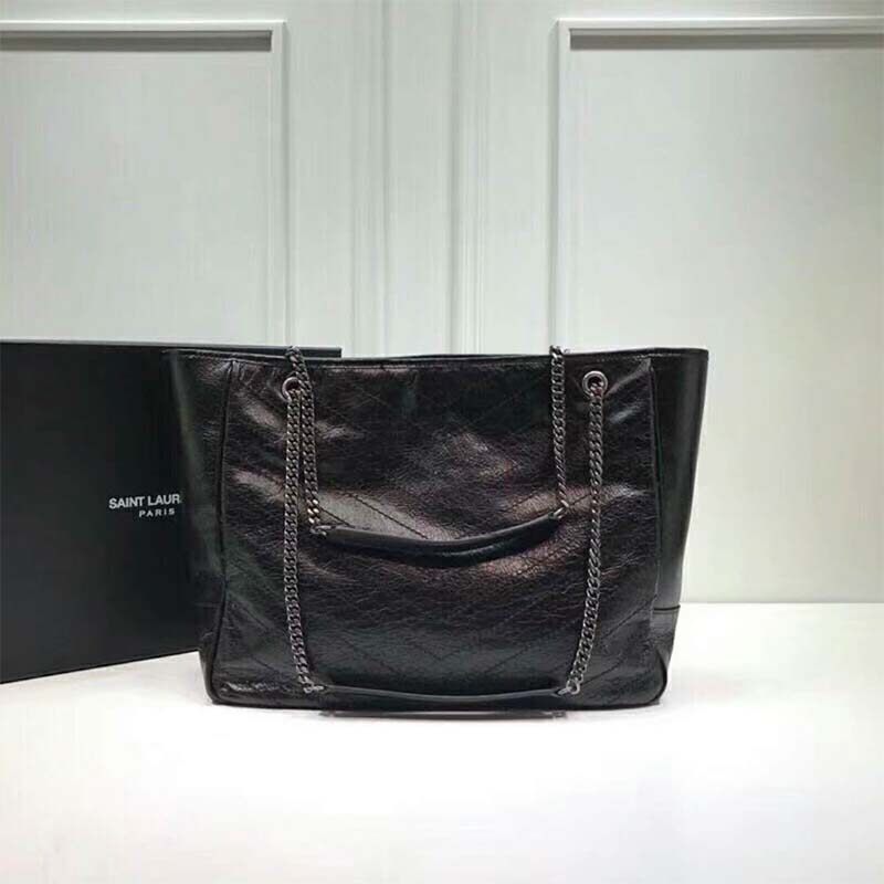 Side angle showing spacious interior and shoulder strap of Saint Laurent YSL shopping bag