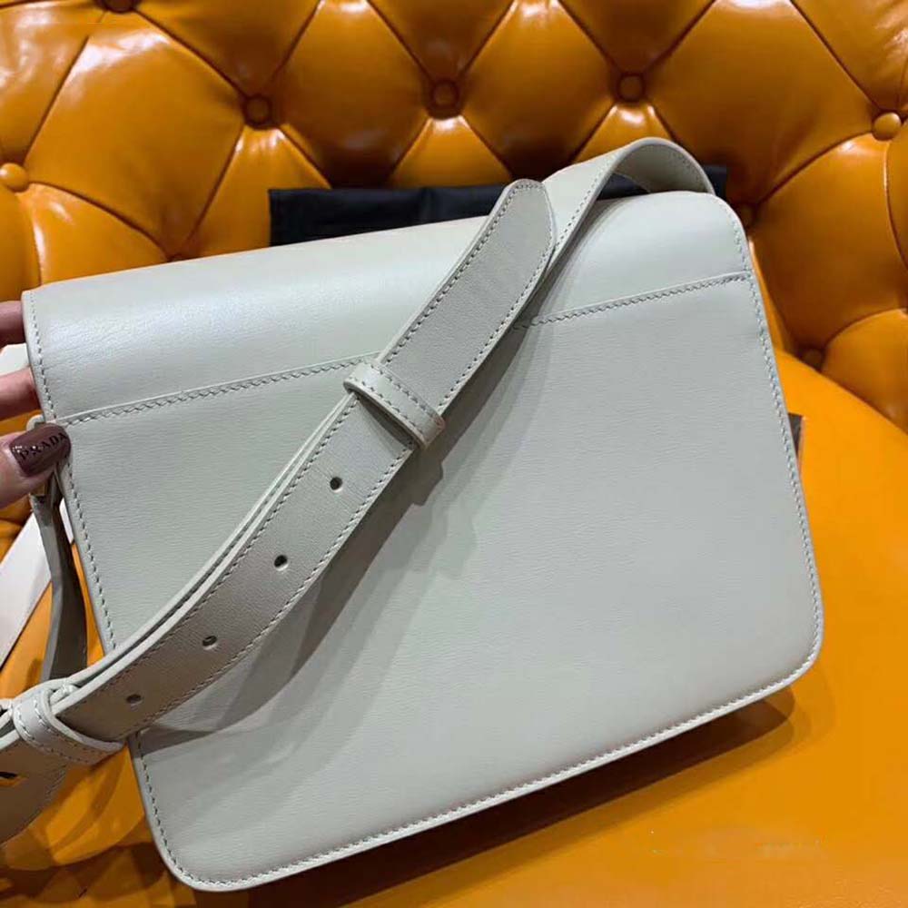 Side angle showing saddle shape and leather texture of Saint Laurent YSL bag
