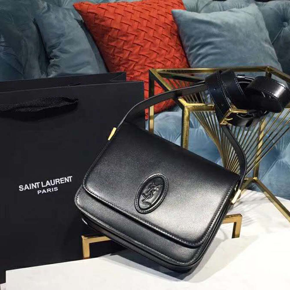 Side angle showing smooth leather texture and flap closure of Saint Laurent YSL Women Le 61 Small Saddle Bag Smooth