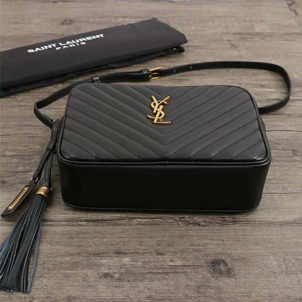 Side profile showing black matelassé leather texture on Saint Laurent bag