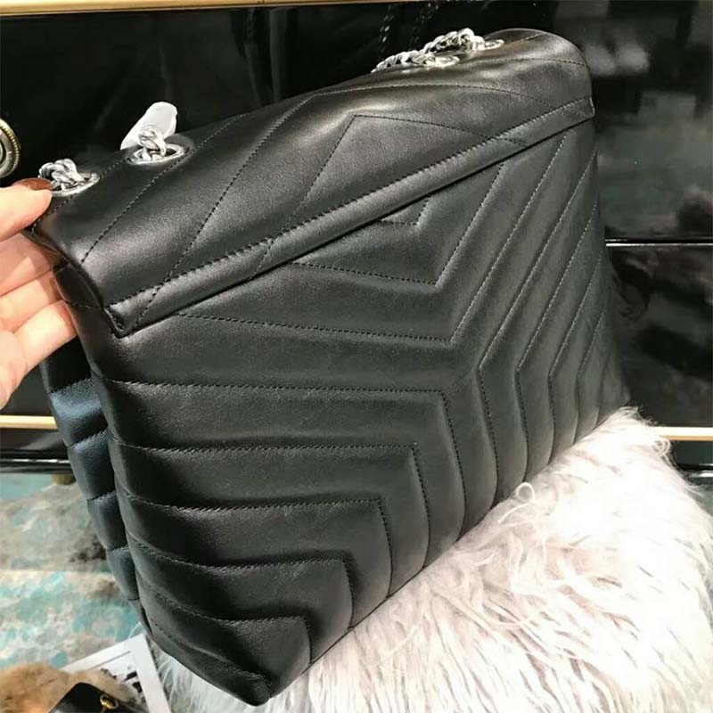 Side angle showing adjustable chain strap on Saint Laurent YSL medium bag