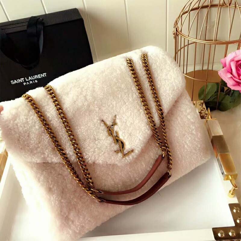 Close-up on gold-tone YSL logo hardware of Loulou Medium Shearling-White