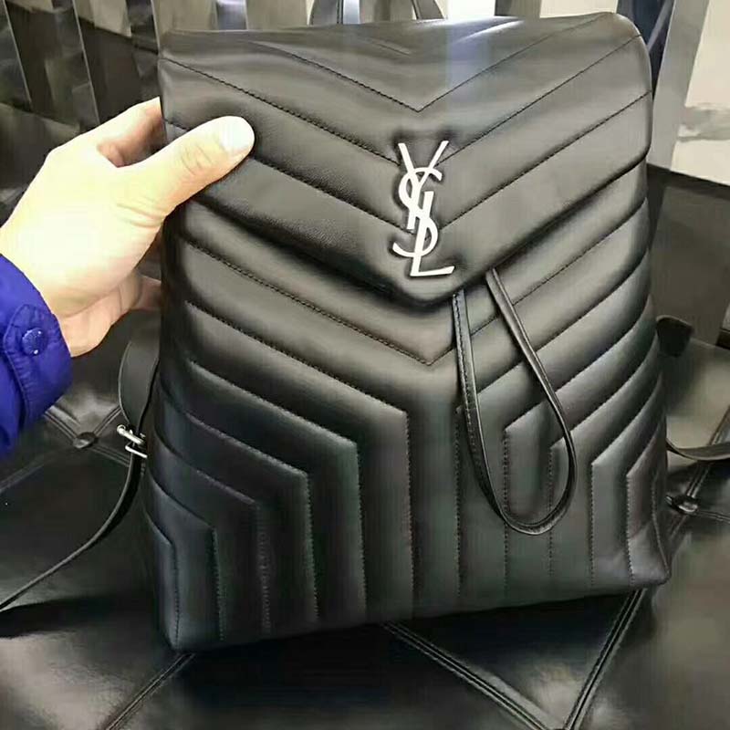 Close-up of silver YSL hardware on black matelassé leather backpack