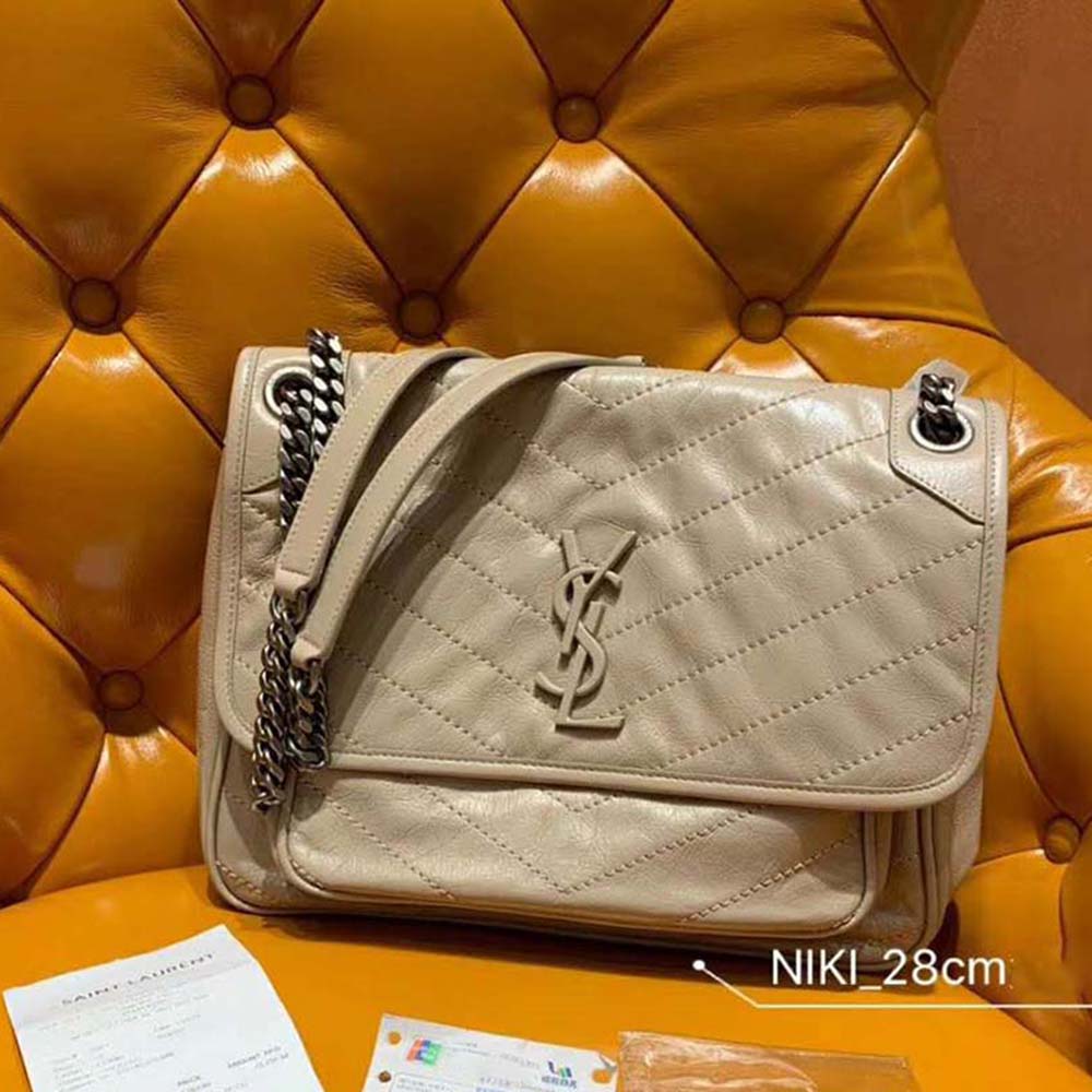 Close-up of gold YSL logo hardware on Saint Laurent YSL Medium Niki Bag