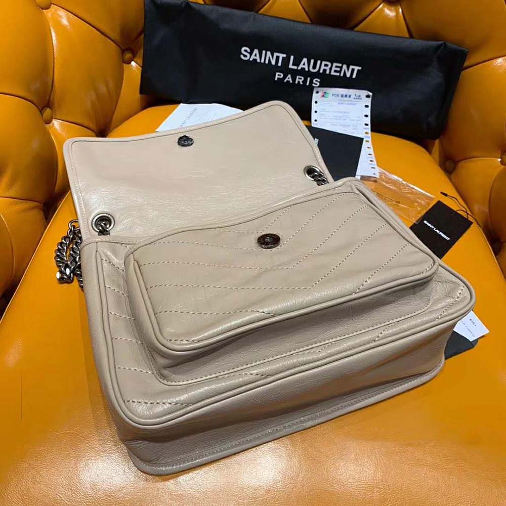 Side angle showing sandy crinkled leather texture on Saint Laurent YSL Niki Bag