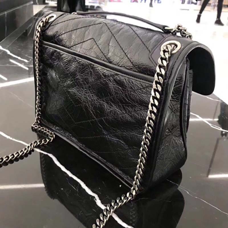 Side angle showing crinkled quilted texture on Saint Laurent Medium Niki Chain bag