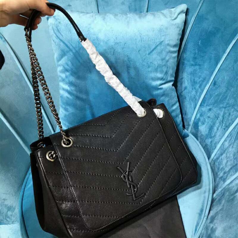 Side view showing vintage black leather texture on Saint Laurent Nolita bag