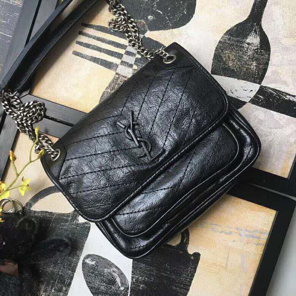 Side angle showing crinkled leather texture on Saint Laurent YSL Niki Baby bag