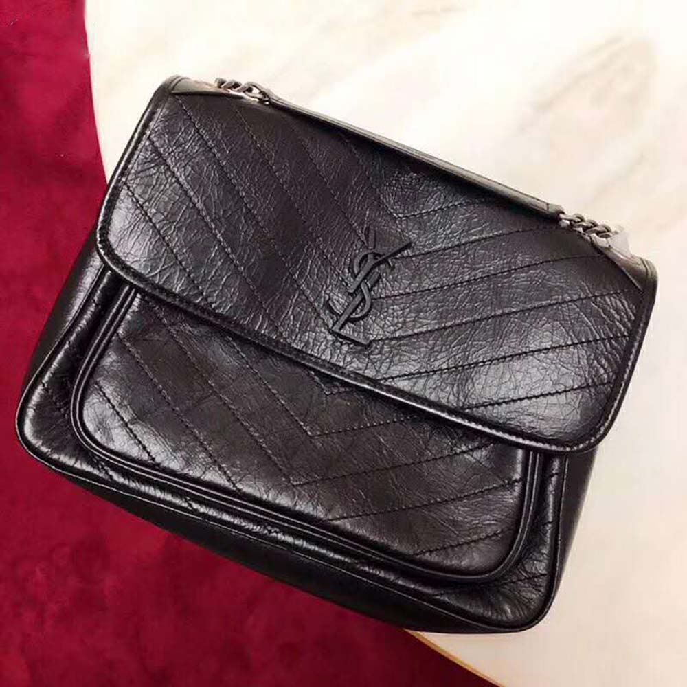 Side profile showing flap closure on Saint Laurent YSL Niki Large handbag