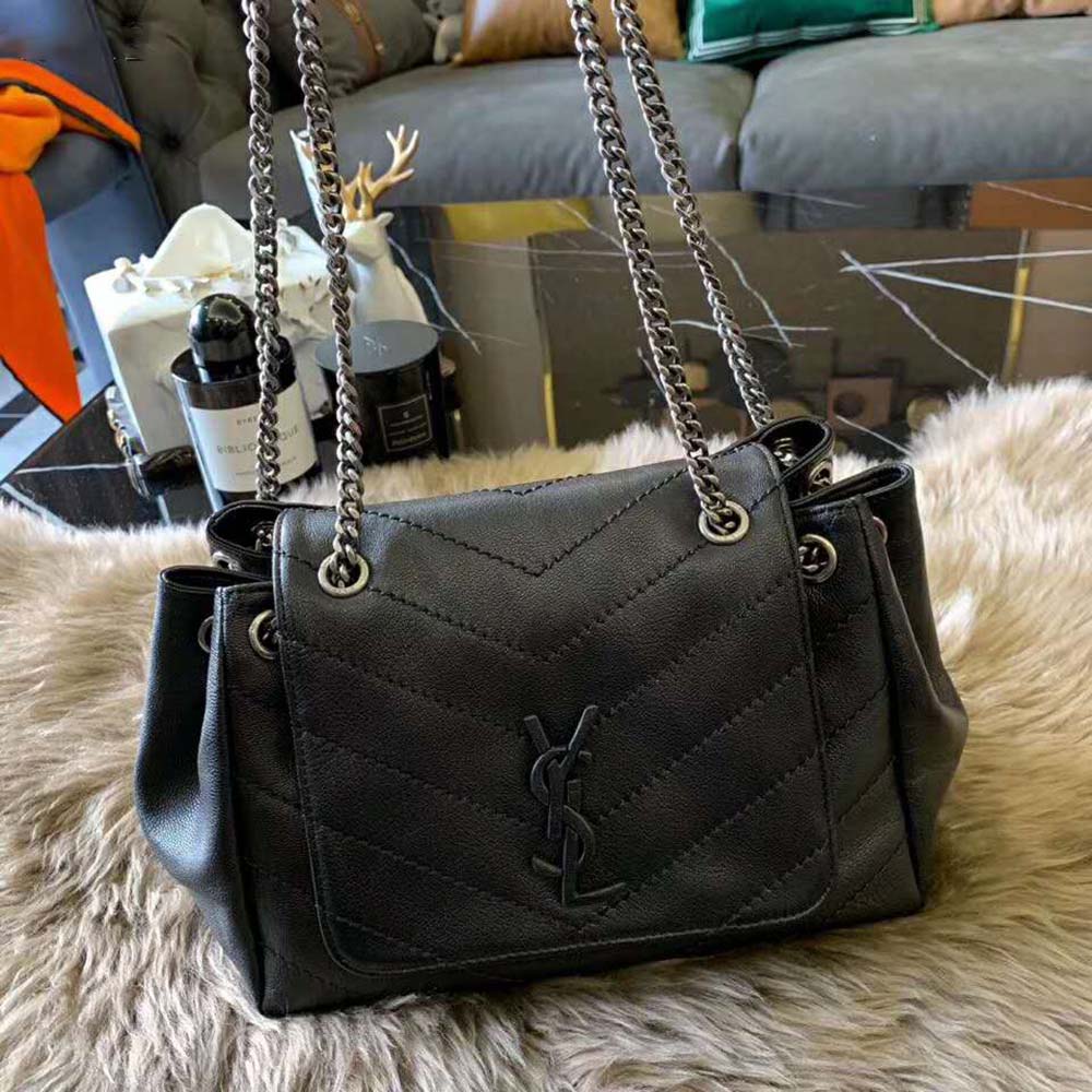 Close-up of gold YSL logo and chain on Nolita Small Bag black leather