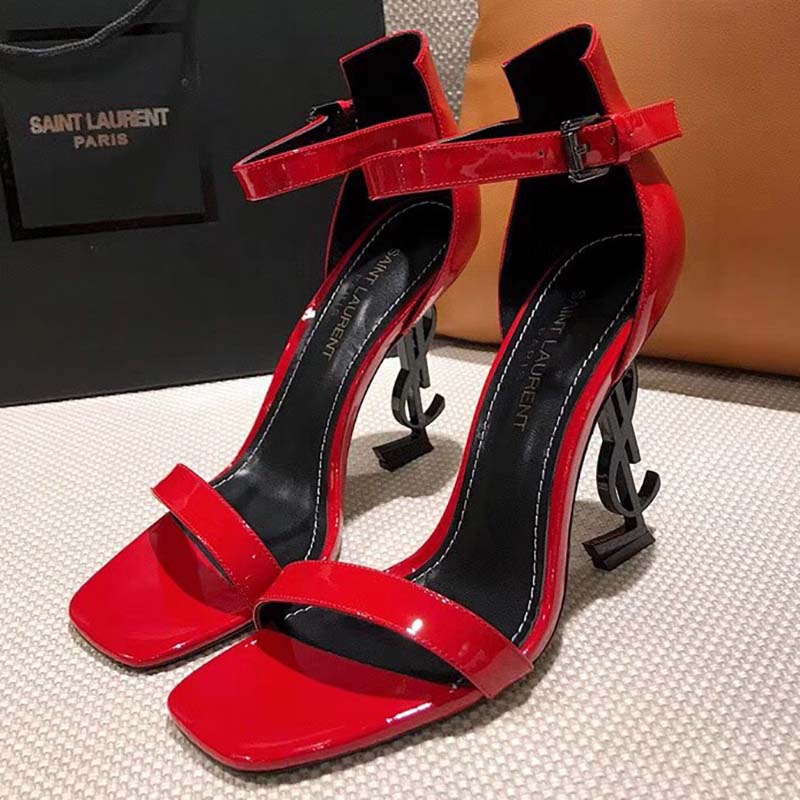 Close-up on signature YSL logo heel of red patent leather sandals