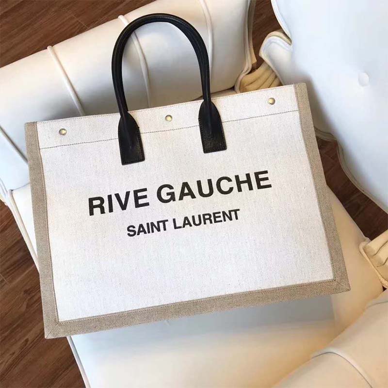 Close-up on gold YSL logo hardware on Saint Laurent Women Rive Gauche Tote Bag