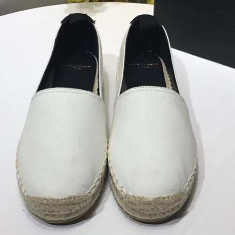 Top view of white cotton espadrilles showcasing classic slip-on design