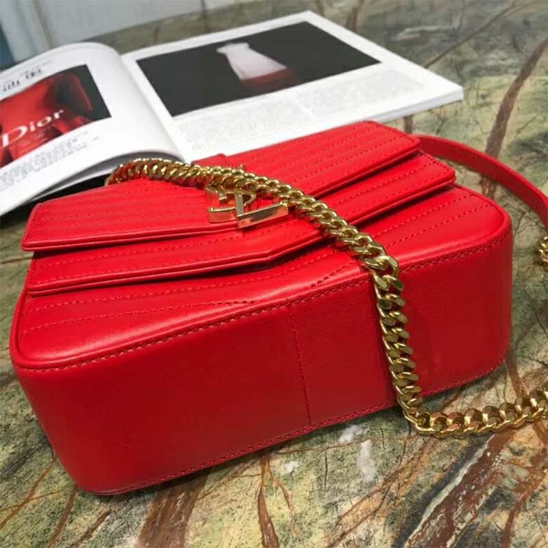 Close-up on gold YSL logo hardware and quilted leather detail