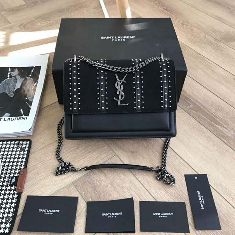 Close-up on gold studs and YSL logo of Saint Laurent Sunset shoulder bag