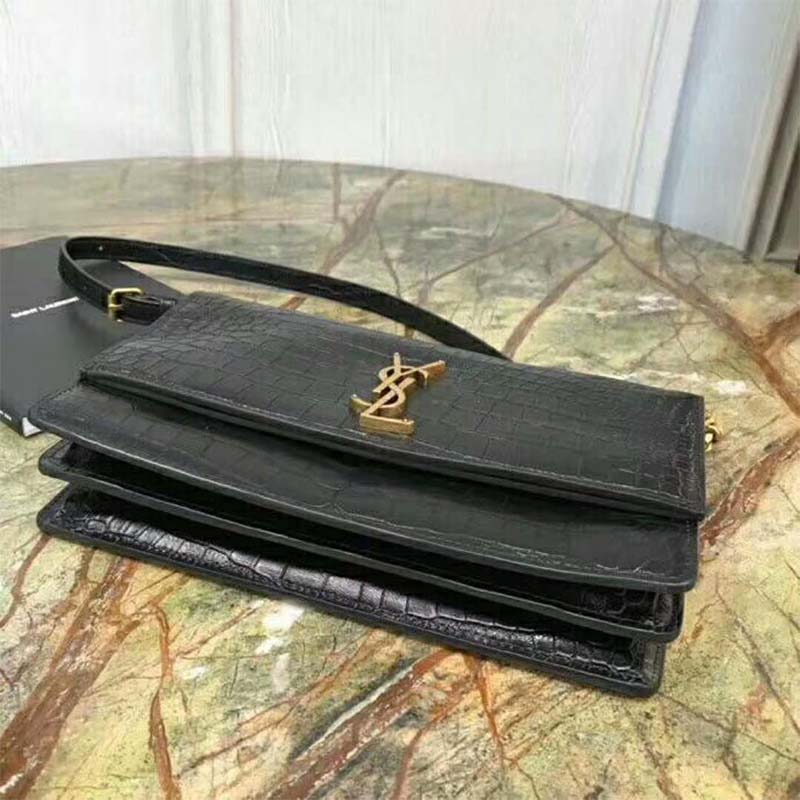 Close-up of gold YSL hardware on Sunset Medium Crocodile Embossed bag