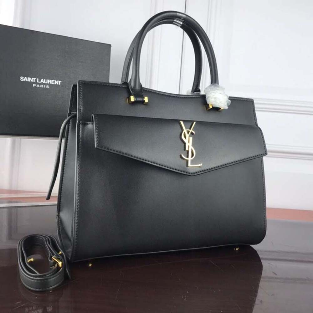 Side profile showing smooth leather texture of Saint Laurent Uptown Medium Tote