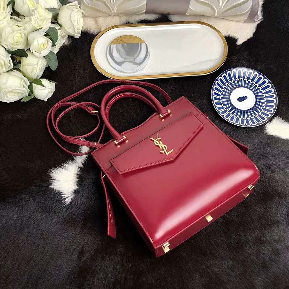 Close-up detail of gold YSL logo on Uptown Small Tote Red leather