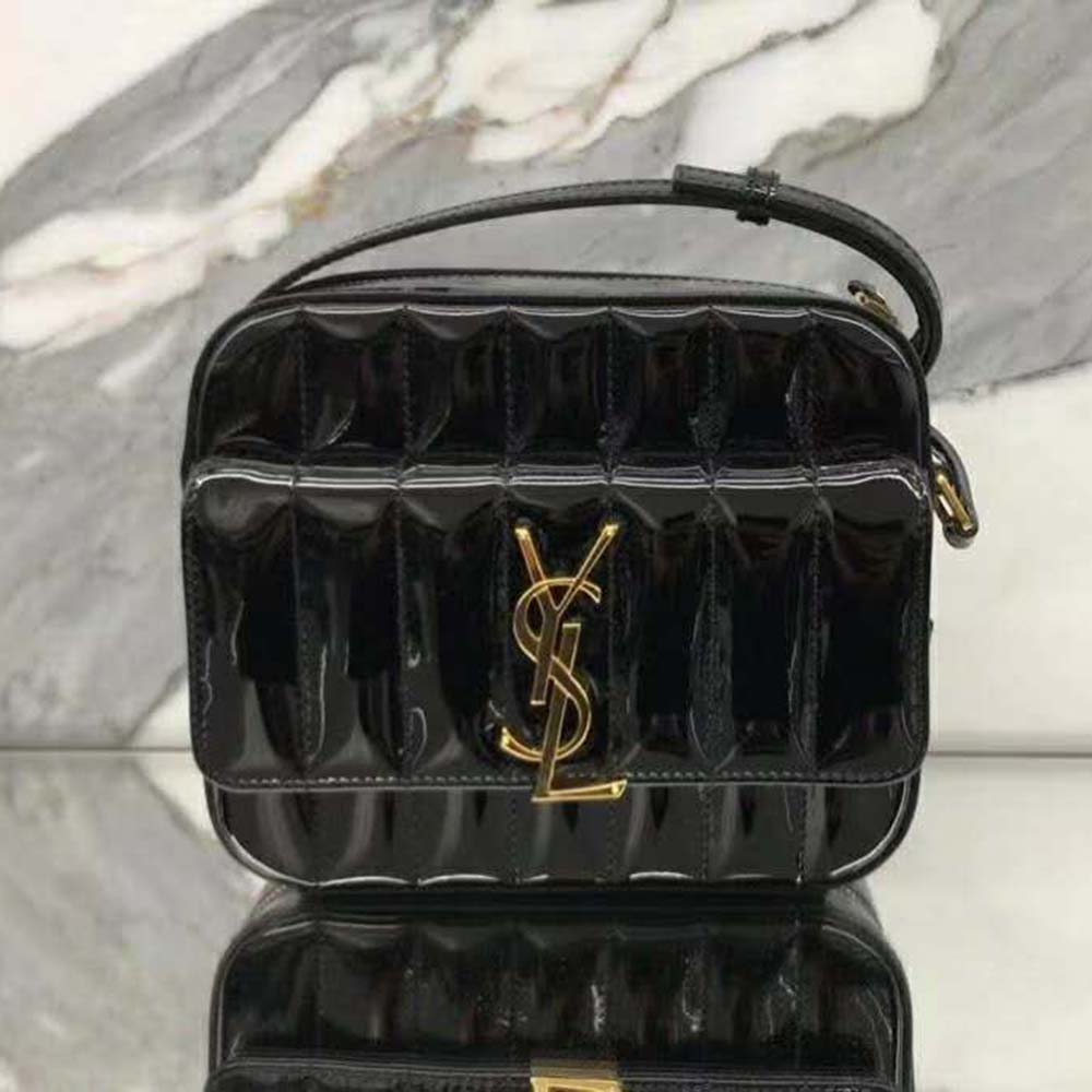 Close-up on gold-tone YSL logo clasp on Vicky Camera Bag