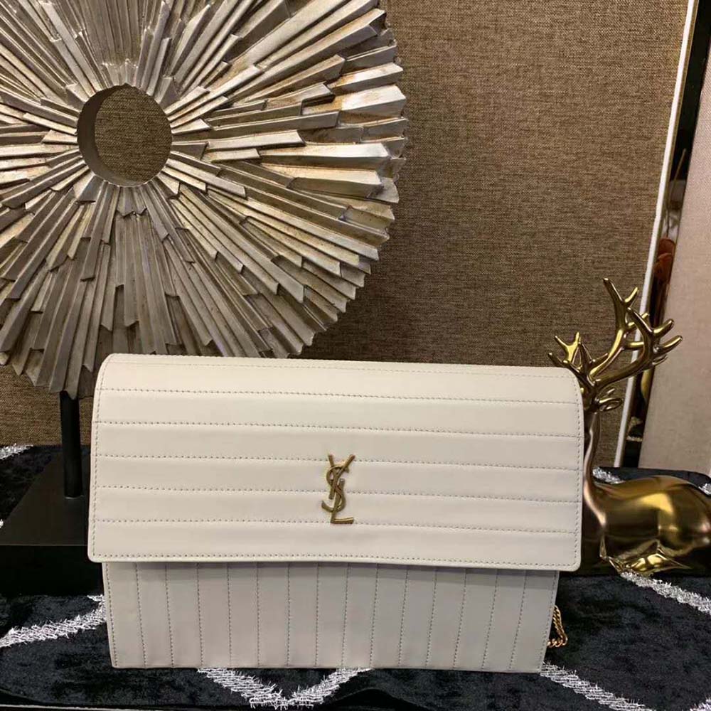 Close-up of gold YSL chain strap and clasp detail on Saint Laurent bag
